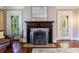 Bright living room featuring hardwood floors, a fireplace, and multiple windows at 27 S Avondale Rd, Avondale Estates, GA 30002