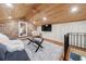 Charming living room features a brick wall, wood ceiling, and plush shag carpet at 27 S Avondale Rd, Avondale Estates, GA 30002