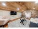Cozy living room with wood ceiling, exposed brick accent wall, and a plush shag rug at 27 S Avondale Rd, Avondale Estates, GA 30002