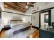 The main bedroom showcases a wood ceiling, hardwood floors, and access to the bathroom at 27 S Avondale Rd, Avondale Estates, GA 30002