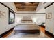 This comfortable main bedroom features a wood ceiling, hardwood floors, and a large window at 27 S Avondale Rd, Avondale Estates, GA 30002