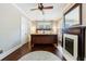 Inviting main bedroom featuring dark wood floors, fireplace, ceiling fan and abundant natural light from shuttered windows at 27 S Avondale Rd, Avondale Estates, GA 30002