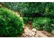 Stone pathway leading through lush greenery, creating a serene outdoor space at 27 S Avondale Rd, Avondale Estates, GA 30002