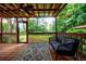 Inviting screened porch with wooded views, ceiling fan, and comfortable seating area at 27 S Avondale Rd, Avondale Estates, GA 30002
