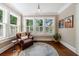 Comfortable sitting area featuring a leather armchair, a round rug, and natural light at 27 S Avondale Rd, Avondale Estates, GA 30002