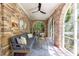 Beautiful sunroom with brick walls, large windows, and cozy seating area for relaxation and enjoyment of nature at 27 S Avondale Rd, Avondale Estates, GA 30002