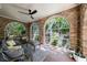Inviting sunroom with brick walls, arched windows, and cozy seating area overlooking lush greenery at 27 S Avondale Rd, Avondale Estates, GA 30002