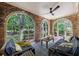 Brick sunroom with arched windows offering views of the garden and comfortable seating at 27 S Avondale Rd, Avondale Estates, GA 30002
