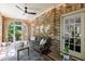 Charming sunroom featuring brick walls, tiled floors, and ample seating perfect for relaxation at 27 S Avondale Rd, Avondale Estates, GA 30002