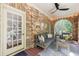 Cozy sunroom with brick walls, string lights, and comfortable seating for year-round enjoyment at 27 S Avondale Rd, Avondale Estates, GA 30002