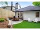 The backyard features a patio with a dining table and chairs and a manicured lawn at 626 Elmwood Ne Dr, Atlanta, GA 30306