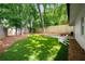 The backyard features a patio with a dining table and chairs, manicured lawn, and a privacy fence at 626 Elmwood Ne Dr, Atlanta, GA 30306