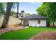 The backyard features a patio with a dining table and chairs, manicured lawn, and a privacy fence at 626 Elmwood Ne Dr, Atlanta, GA 30306