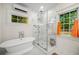 This bathroom boasts a modern tub and glass shower, and a bright window for natural light at 626 Elmwood Ne Dr, Atlanta, GA 30306