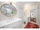 Bright bathroom featuring double sinks, marble countertops, and a luxurious glass-enclosed shower at 626 Elmwood Ne Dr, Atlanta, GA 30306