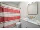 Bright bathroom features marble countertop, gold fixtures, and decorative shower curtain at 626 Elmwood Ne Dr, Atlanta, GA 30306