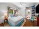 Bright bedroom featuring built-in shelves, hardwood floors and colorful curtains at 626 Elmwood Ne Dr, Atlanta, GA 30306