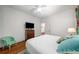 Bright bedroom featuring hardwood floors, ceiling fan and comfortable bed at 626 Elmwood Ne Dr, Atlanta, GA 30306
