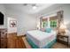 Bright bedroom featuring hardwood floors, comfortable bed and colorful curtains at 626 Elmwood Ne Dr, Atlanta, GA 30306