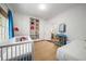 Bright bedroom with built-in shelves, comfortable bed and crib at 626 Elmwood Ne Dr, Atlanta, GA 30306