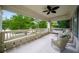 Inviting front porch with wicker seating, porch swing, and a ceiling fan at 626 Elmwood Ne Dr, Atlanta, GA 30306