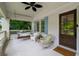 Inviting front porch with wicker seating, porch swing, and white brick accents at 626 Elmwood Ne Dr, Atlanta, GA 30306