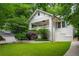 Charming white brick home with a covered front porch and meticulously kept landscaping at 626 Elmwood Ne Dr, Atlanta, GA 30306