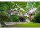 Charming white brick home featuring a well-maintained lawn and front porch at 626 Elmwood Ne Dr, Atlanta, GA 30306
