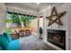 Inviting outdoor patio with stone flooring, a fireplace, and comfortable seating area with an outdoor grill at 626 Elmwood Ne Dr, Atlanta, GA 30306