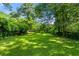 Large grassy backyard with mature trees, perfect for outdoor activities at 1556 Braeburn Se Dr, Atlanta, GA 30316