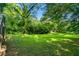 Expansive backyard featuring a lush lawn with mature trees at 1556 Braeburn Se Dr, Atlanta, GA 30316