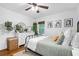 This serene bedroom has a dresser with mirror and wicker laundry basket. There are hardwood floors and neutral decor at 1556 Braeburn Se Dr, Atlanta, GA 30316