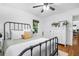 Bright and airy bedroom featuring hardwood floors, a comfortable bed, and a dresser at 1556 Braeburn Se Dr, Atlanta, GA 30316