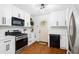 Well-lit kitchen features white cabinets, stainless steel appliances, and a door to the backyard at 1556 Braeburn Se Dr, Atlanta, GA 30316
