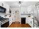 Bright kitchen features white cabinets, stainless steel appliances, and hardwood floors at 1556 Braeburn Se Dr, Atlanta, GA 30316