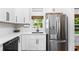 Updated kitchen featuring white cabinets, stainless steel appliances, and a window over the sink at 1556 Braeburn Se Dr, Atlanta, GA 30316