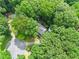 A lushly wooded property view highlights the privacy of the home nestled among tall, mature trees at 200 Zachary Woods Nw Pt, Marietta, GA 30064