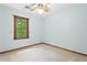 Bright carpeted room features a window offering an exterior view and modern ceiling fan at 200 Zachary Woods Nw Pt, Marietta, GA 30064