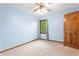 Cozy carpeted bedroom with a natural wood door and view of trees outside the window at 200 Zachary Woods Nw Pt, Marietta, GA 30064