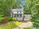 Traditional style home with 2-car garage, front porch, surrounded by mature trees at 200 Zachary Woods Nw Pt, Marietta, GA 30064