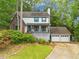 Charming two-story home with a brick accent, a front porch, an attached garage, and a beautiful landscaped yard at 200 Zachary Woods Nw Pt, Marietta, GA 30064