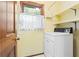 Cozy laundry room with washer and dryer, shelving, and a window providing natural light at 200 Zachary Woods Nw Pt, Marietta, GA 30064