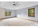 Spacious primary bedroom with tray ceiling and large windows providing ample natural light at 200 Zachary Woods Nw Pt, Marietta, GA 30064