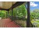 Inviting covered porch with wooden floors, railing, decorative supports and view of the landscaped front yard at 200 Zachary Woods Nw Pt, Marietta, GA 30064
