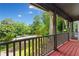 Inviting covered porch with wooden floors, railing, decorative supports and view of the landscaped front yard at 200 Zachary Woods Nw Pt, Marietta, GA 30064