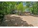 Exterior showcasing a home with mature trees, a well-manicured yard and an attached garage at 285 Glen Lake Dr, Atlanta, GA 30327