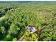 A stunning aerial view showcasing the home amidst a dense, picturesque forest at 338 Mount Zion Rd, Oxford, GA 30054