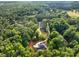 Panoramic aerial view featuring two homes, each with private driveways surrounded by lush green trees at 338 Mount Zion Rd, Oxford, GA 30054