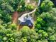Aerial view of the home nestled among lush greenery, with a winding driveway leading to the property at 338 Mount Zion Rd, Oxford, GA 30054