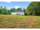 Spacious backyard featuring a side view of the house and an expansive lawn at 338 Mount Zion Rd, Oxford, GA 30054